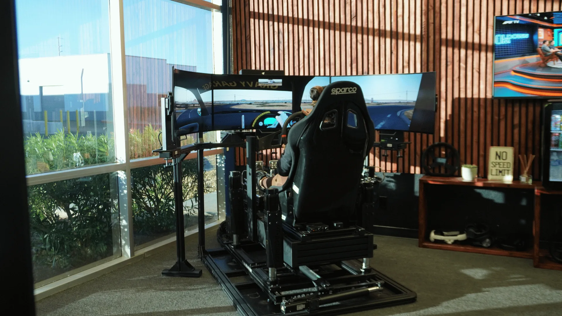 Driver racing on a Sim Coaches Elite 6DOF simulator